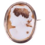 An antique carved hard stone portrait cameo in Victorian brooch mount