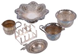 A selection of Victorian and later silver cream jugs, bon bon dish, toast rack and strainer