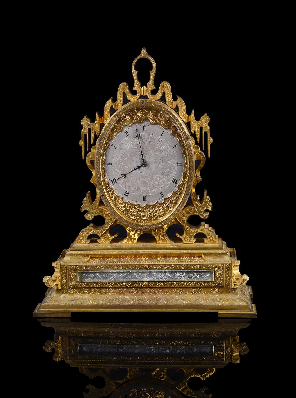 An impressive engraved gilt brass mantle clock in the manner of Thomas Cole