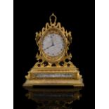 An impressive engraved gilt brass mantle clock in the manner of Thomas Cole