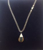 A contemporary amber tear drop pendant on fancy 9ct gold chain