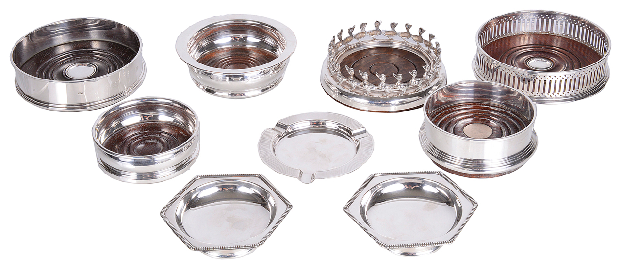 A selection of contemporary silver and silver plated wine bottle coasters, with silver ashtray and d
