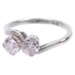 A two stone diamond set crossover platinum mounted ring