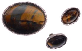 A modernist silver mounted tigers eye brooch and matching earrings