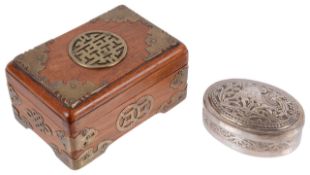 An Oriental oval white metal tobacco box and a Chinese hardwood brass bound box,