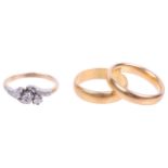 A small three stone diamond ring and two 22ct gold wedding bands