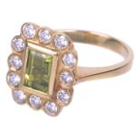 An attractive rectangular peridot and diamond cluster ring