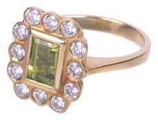 An attractive rectangular peridot and diamond cluster ring