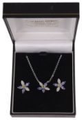 A contemporary tanzanite, diamond and peridot floral pendant on chain and matching earrings