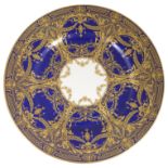A Royal Worcester porcelain plate, the blue ground decorated with gilt hatched border and jewelled g