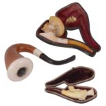 Two cased smoking pipes,