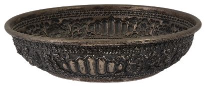 A 19th century Indonesian white metal repousse decorated shallow bowl