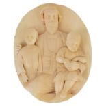 A Victorian carved ivory roundel family portrait