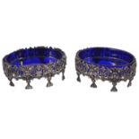 A pair of Edwardian silver salts with blue glass liners