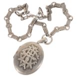 A large Victorian silver locket on fancy neck chain