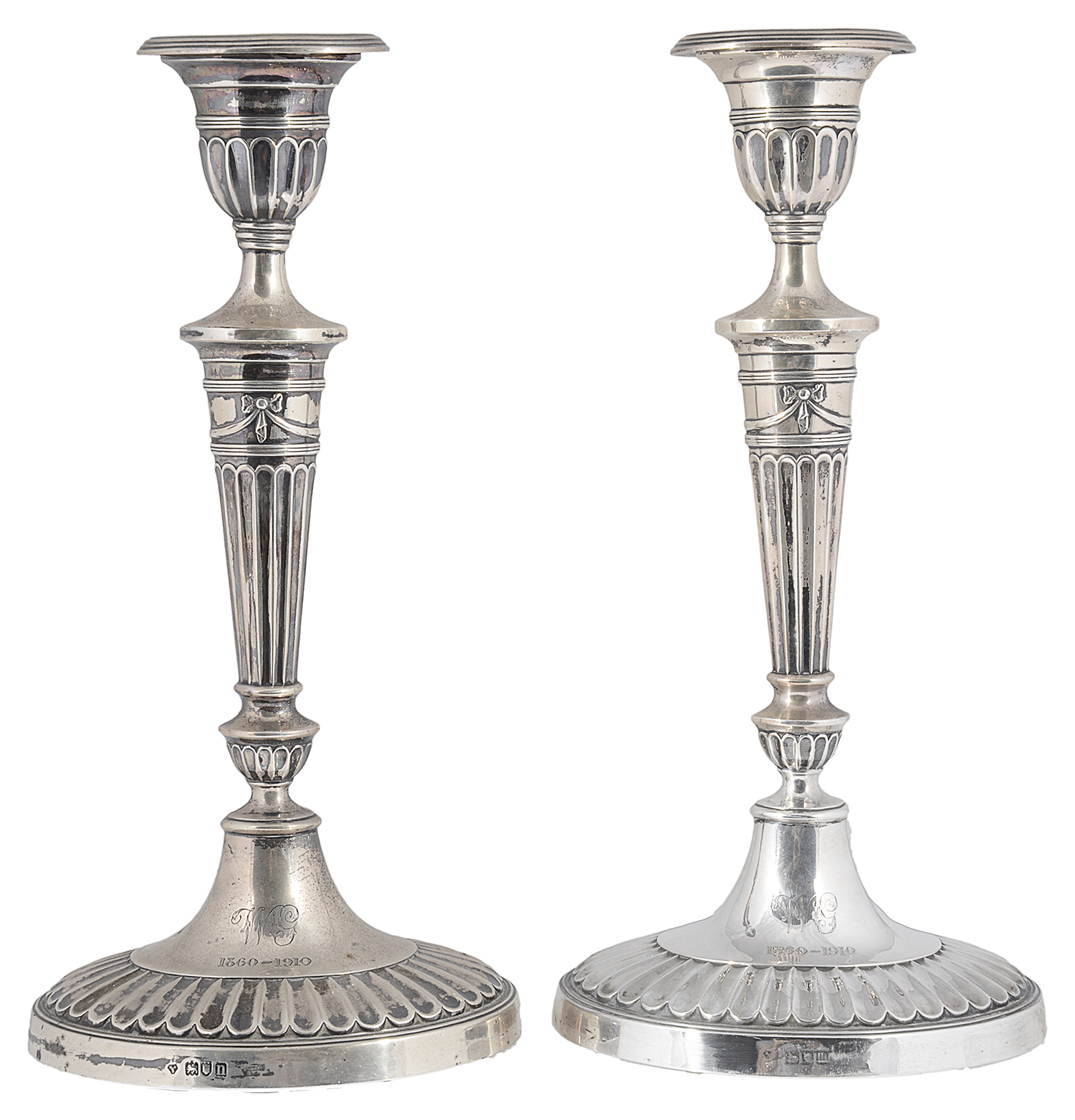 A pair of Edwardian Adam style silver candlesticks, hallmarked London 1907/1908