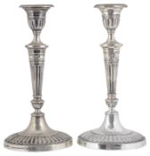 A pair of Edwardian Adam style silver candlesticks, hallmarked London 1907/1908