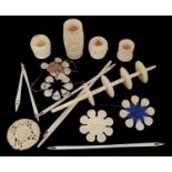 A small collection of bone and ivory sewing accessories including