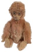 A miniature Schuco monkey compact, early 20th century