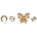 Three small contemporary gold brooches and a large butterfly pin