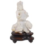 A 19th century Chinese carved pale celadon jade figure of Guanyin