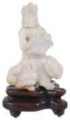 A 19th century Chinese carved pale celadon jade figure of Guanyin