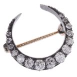 A delicate Victorian diamond set crescent pendant brooch