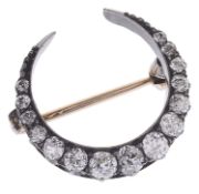 A delicate Victorian diamond set crescent pendant brooch