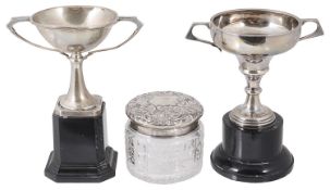 Two George V silver trophy cups and a Victorian silver glass powder jar