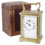 A French four glass brass carriage clock with original travel case