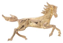 An 18ct gold brooch in the form of a galloping horse