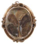 A Victorian yellow metal oval memorial picture brooch