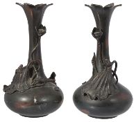 A pair of Japanese Meji period spelter floral trumpet shaped vases