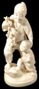 A late 19th century Japanese Meji period ivory Okimono of a father and boy