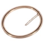 A simple Continental 18ct gold plain hinged bangle