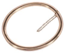 A simple Continental 18ct gold plain hinged bangle