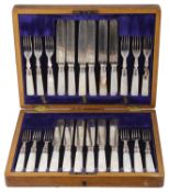 An Edwardian cased set of twelve silver collared mother of pearl dessert knives and forks, hallmarke