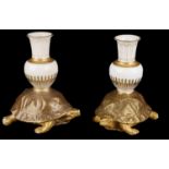 A pair of Royal Worcester aesthetic period tortoise candlesticks(2)
