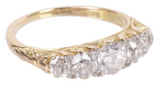 An early 20th c. attractive five stone diamond set half hoop ring