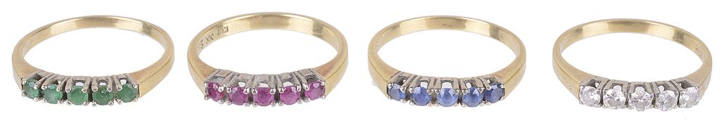 A set of four matching five stone diamond and gem set rings(4)