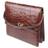 A light brown vintage ladies crocodile leather handbag