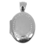 A contemporary 18ct white gold and diamond set oval locket