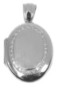 A contemporary 18ct white gold and diamond set oval locket