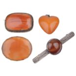 A butterscotch amber heart pendant; three carnelian set brooches(4)