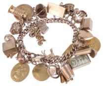 A heavy gold charm bracelet with an interesting variety of gold charms