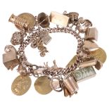 A heavy gold charm bracelet with an interesting variety of gold charms
