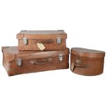 A set of two Vintage leather suitcases and a matching hat box(3)