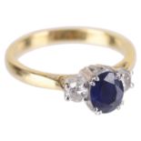A delicate sapphire and diamond three stone ring