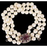 A three row cultured pearl bracelet with garnet set clasp