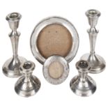 Two pairs of silver candlesticks and silver photograph frames